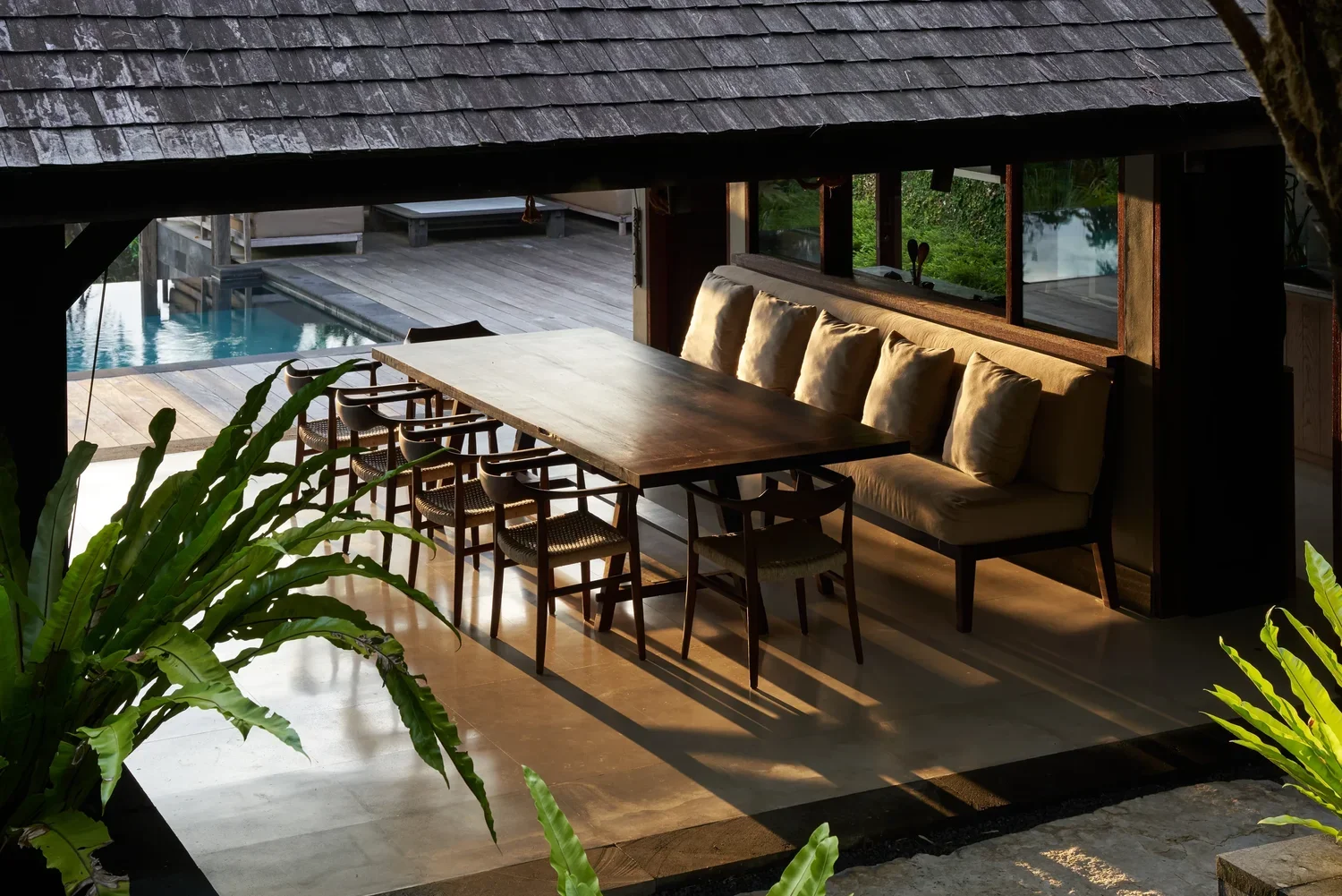Dining room at Rumah Hujan set for a meal with Balinese architectural details