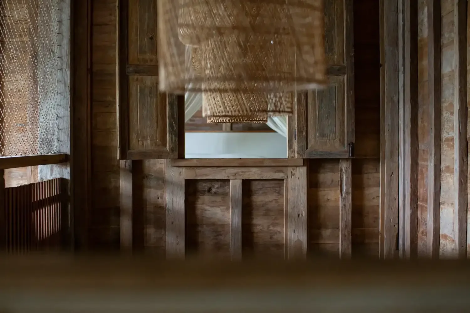 Close-up of hand-finished wood detail at Rumah Hujan, showing craftsmanship