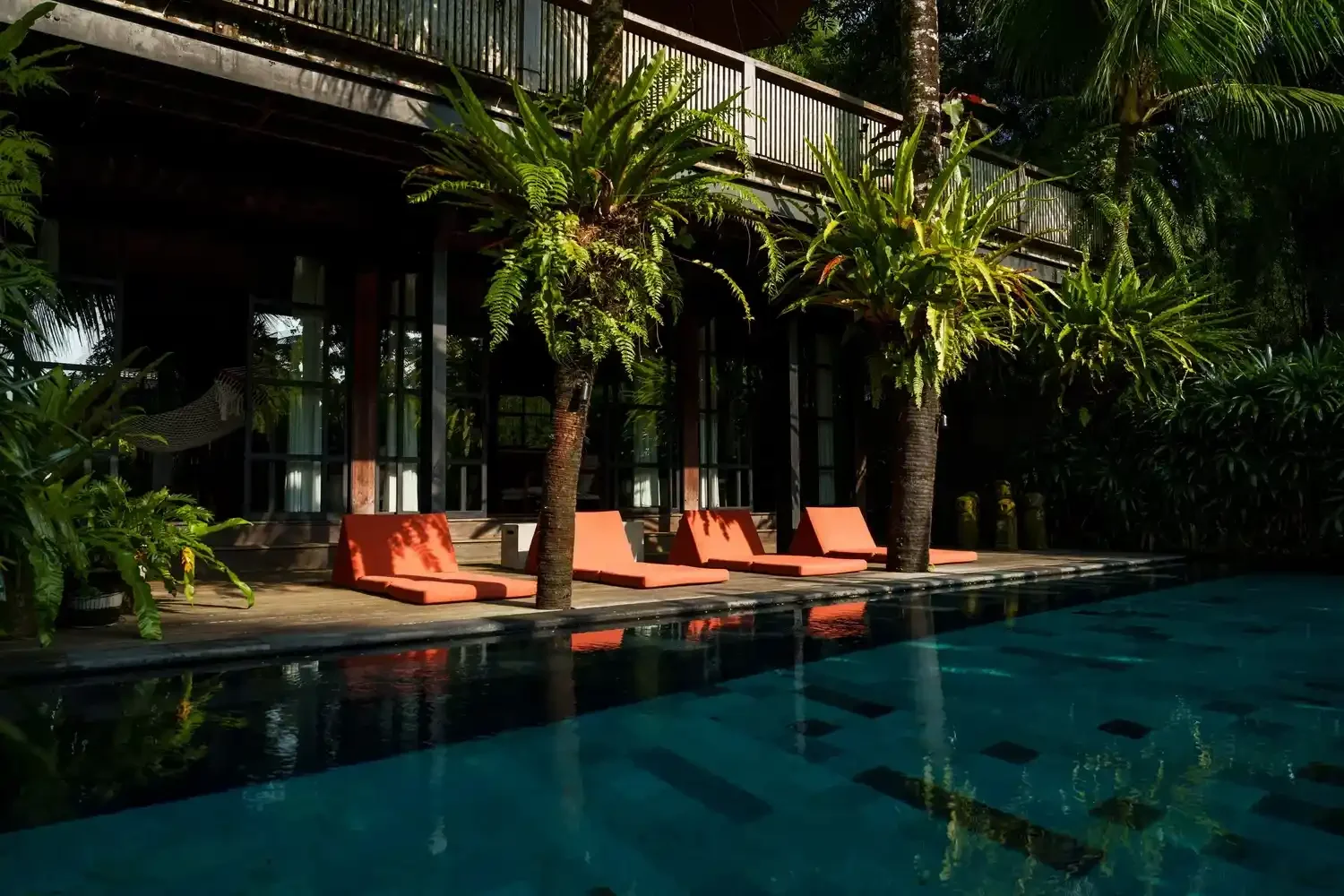 Heated saltwater infinity pool of Rumah Hujan II opening over the jungle canopy below, Ubud