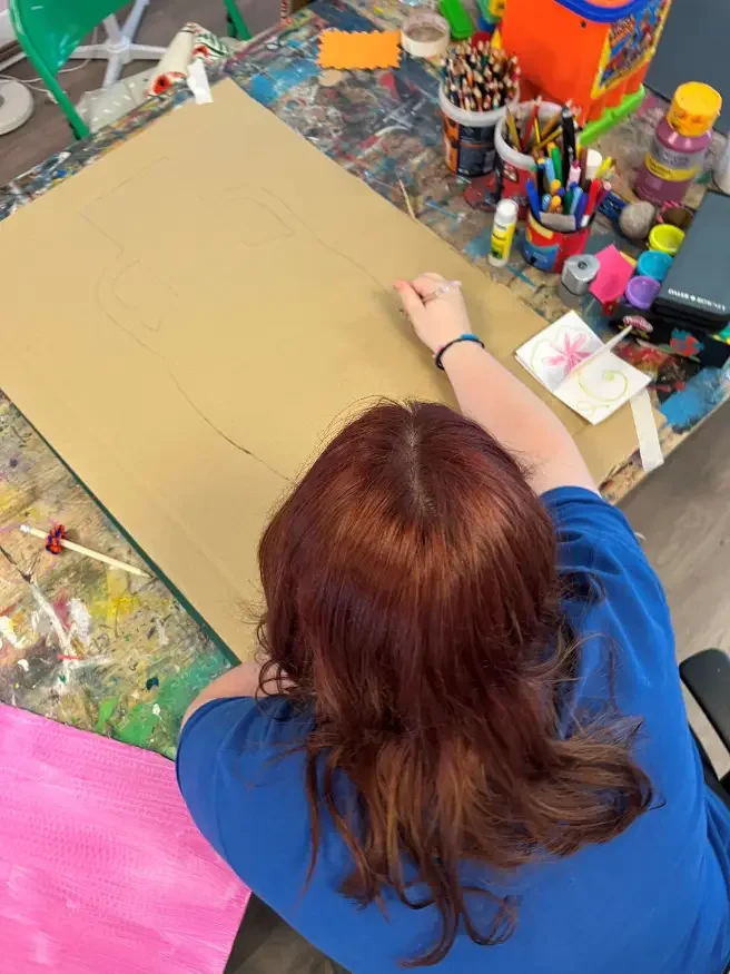 A young person drawing in our art studio