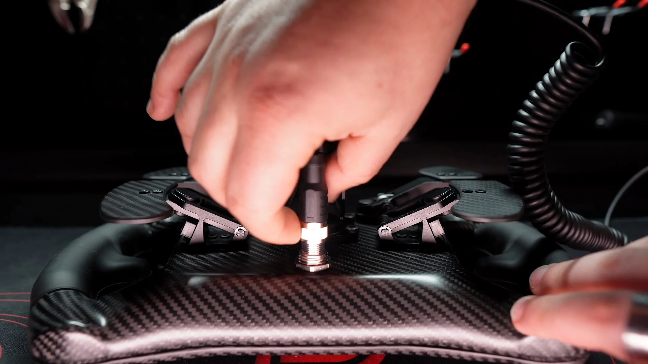 Connecting the cable to the rear of the wheel.