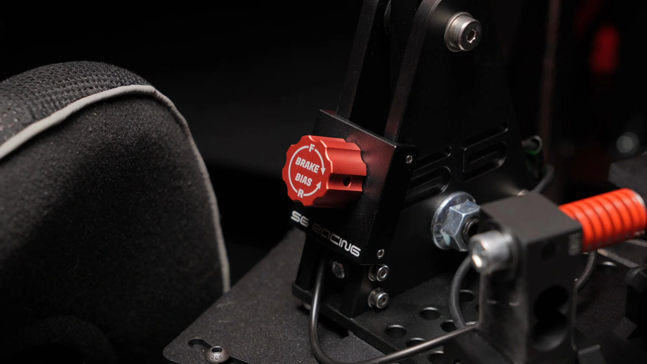The handbrake adjustment knob and spring mechanism.