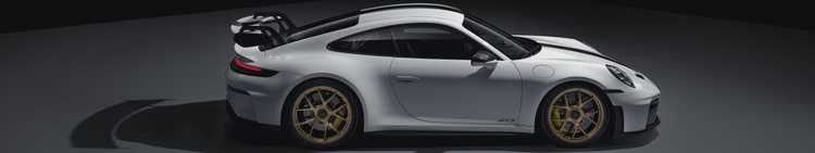 A white Porsche 911 GT3 sports car with black accents and gold wheels, viewed from the side on a dark background.