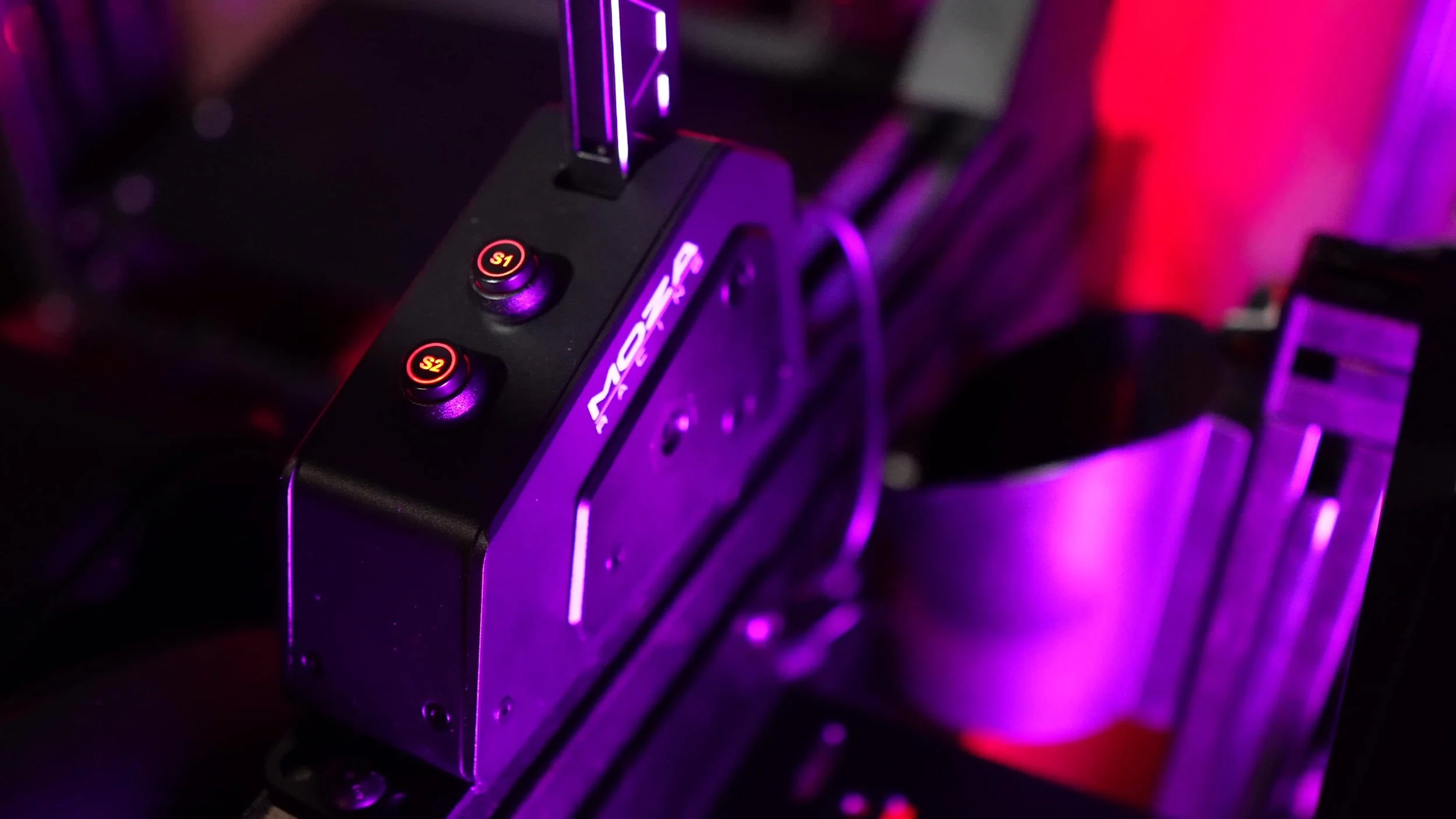 The illuminated auxiliary buttons on the shifter body.