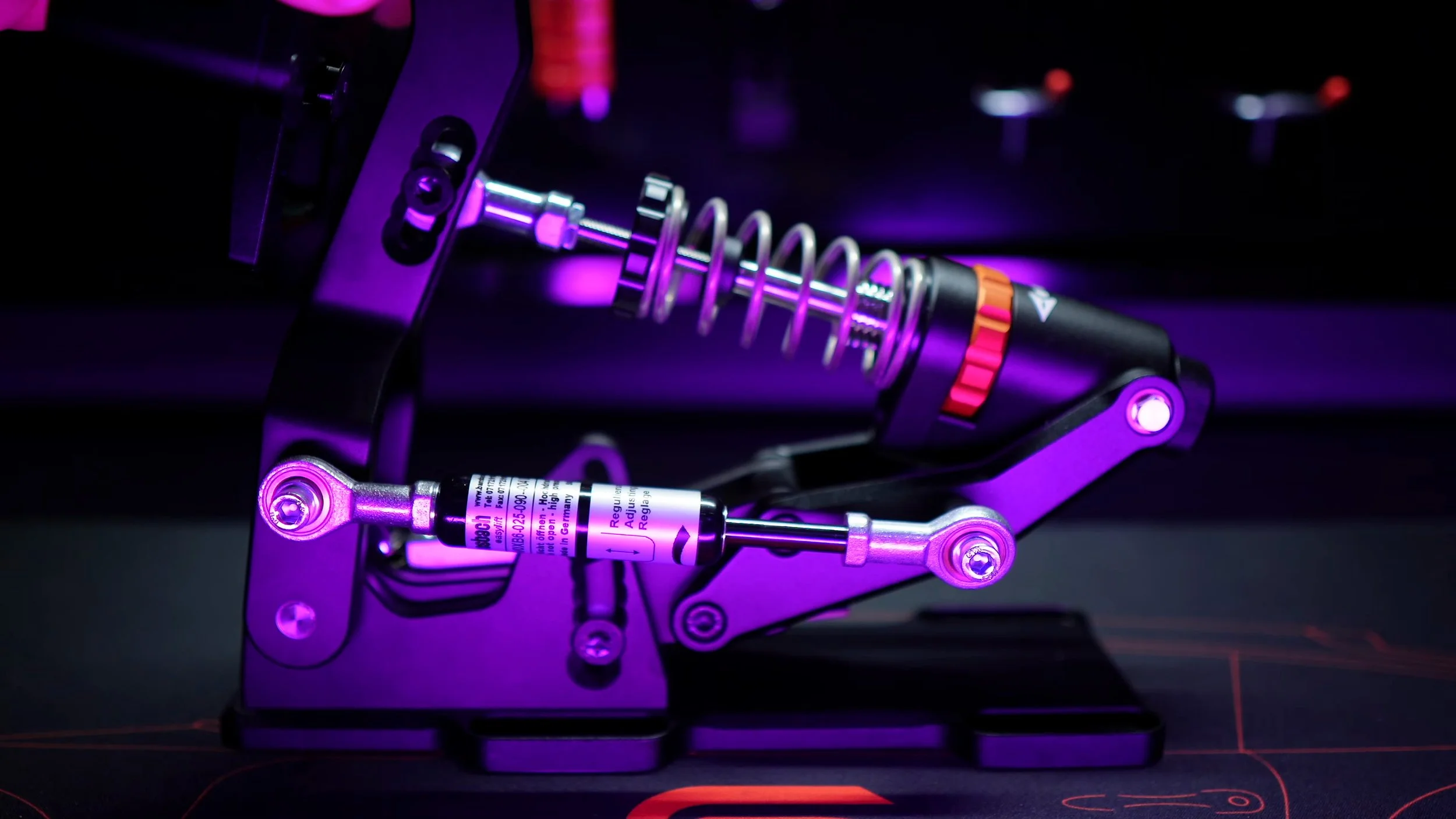 The damper linkage and spring assembly.