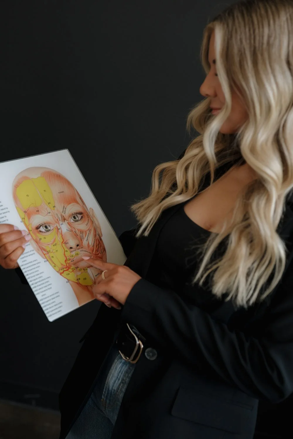 RN nurse injector studying facial anatomy chart injectable expertise A-Class Aesthetics New Berlin WI