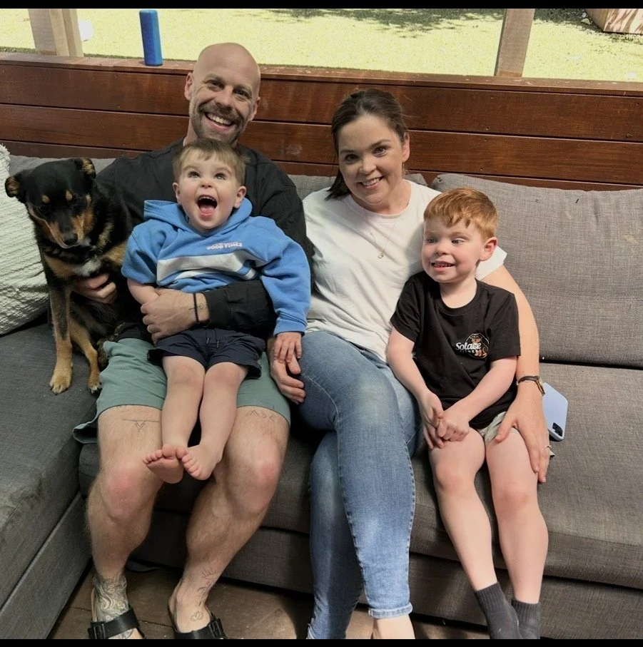 The family behind Solace Fitness sitting together with their dog.