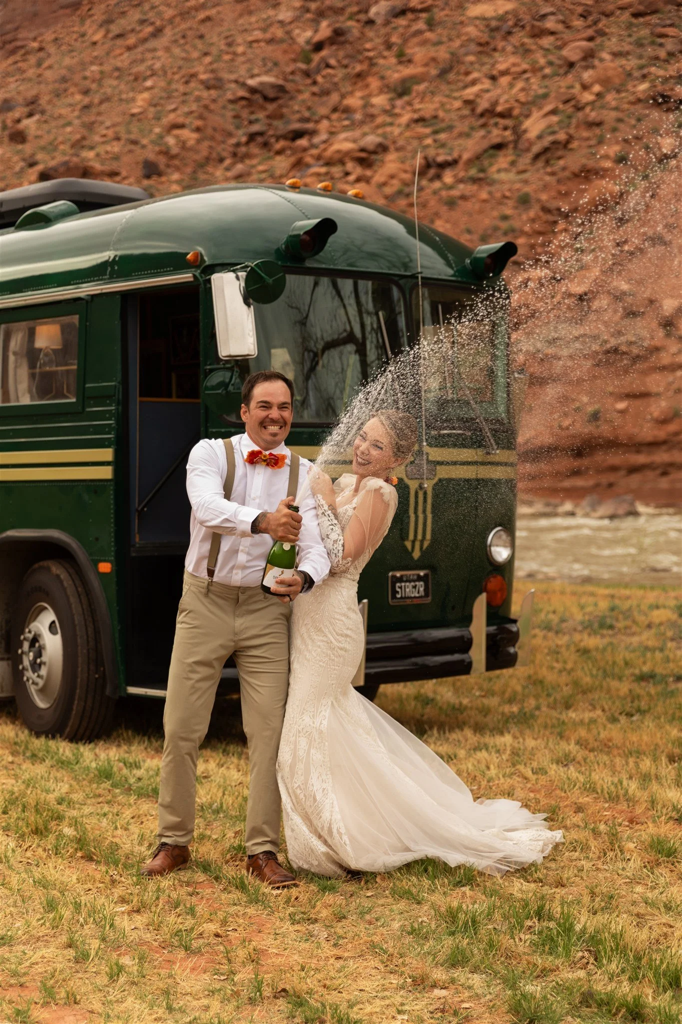 Regina, the vintage Crown bus, parked on the lawn at Red Cliffs Lodge beneath the canyon cliffs