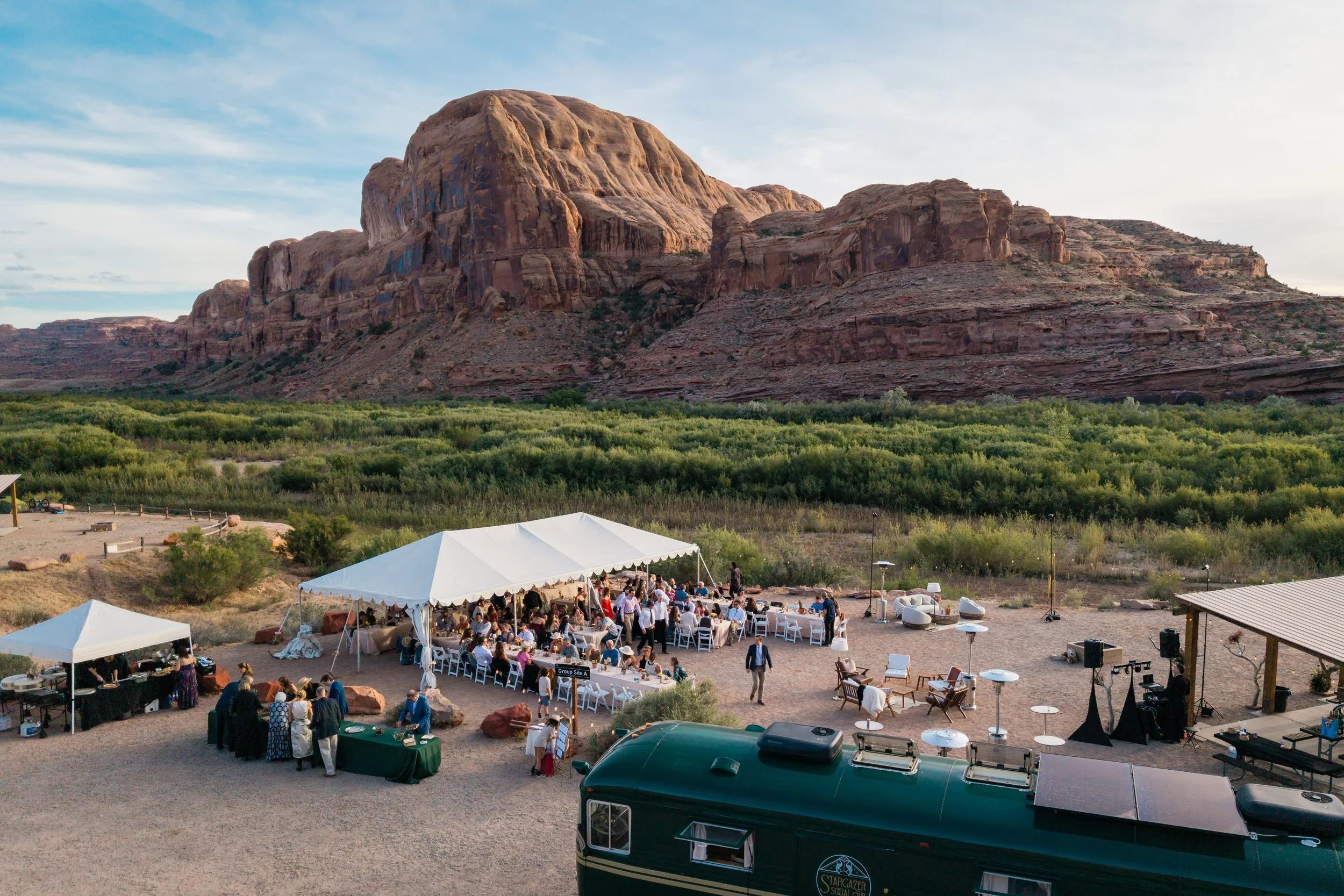 Stargazer's vintage bus bar and lit lounge set in a red-rock desert yard