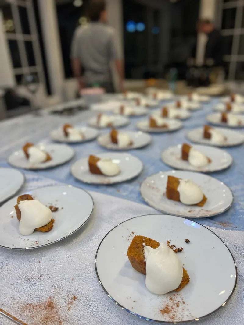 Individual desserts finished with cream, ready for service.
