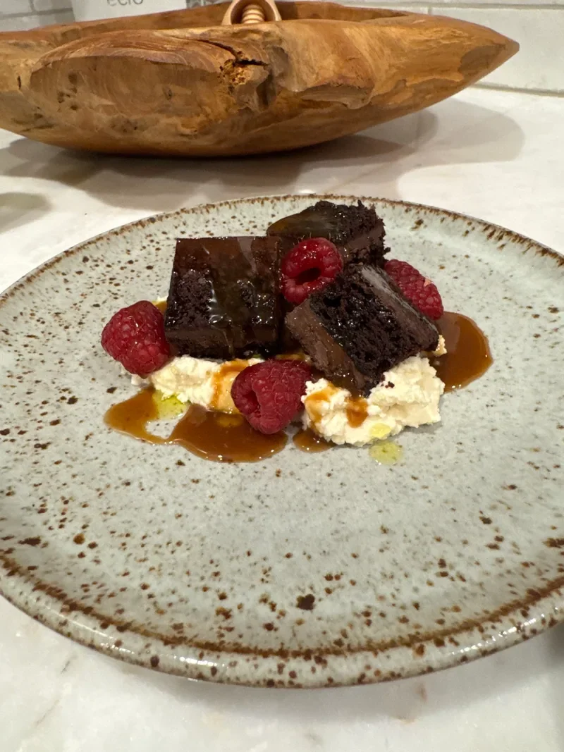 Chocolate dessert with raspberries plated by Chef Collin.