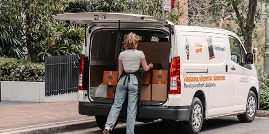 Member loading boxes into a GoGet van