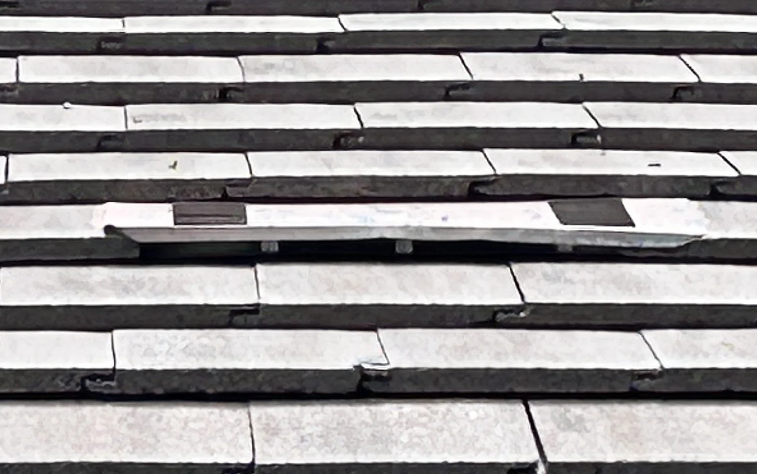 Low-profile roof vent integrated into concrete roof tiles