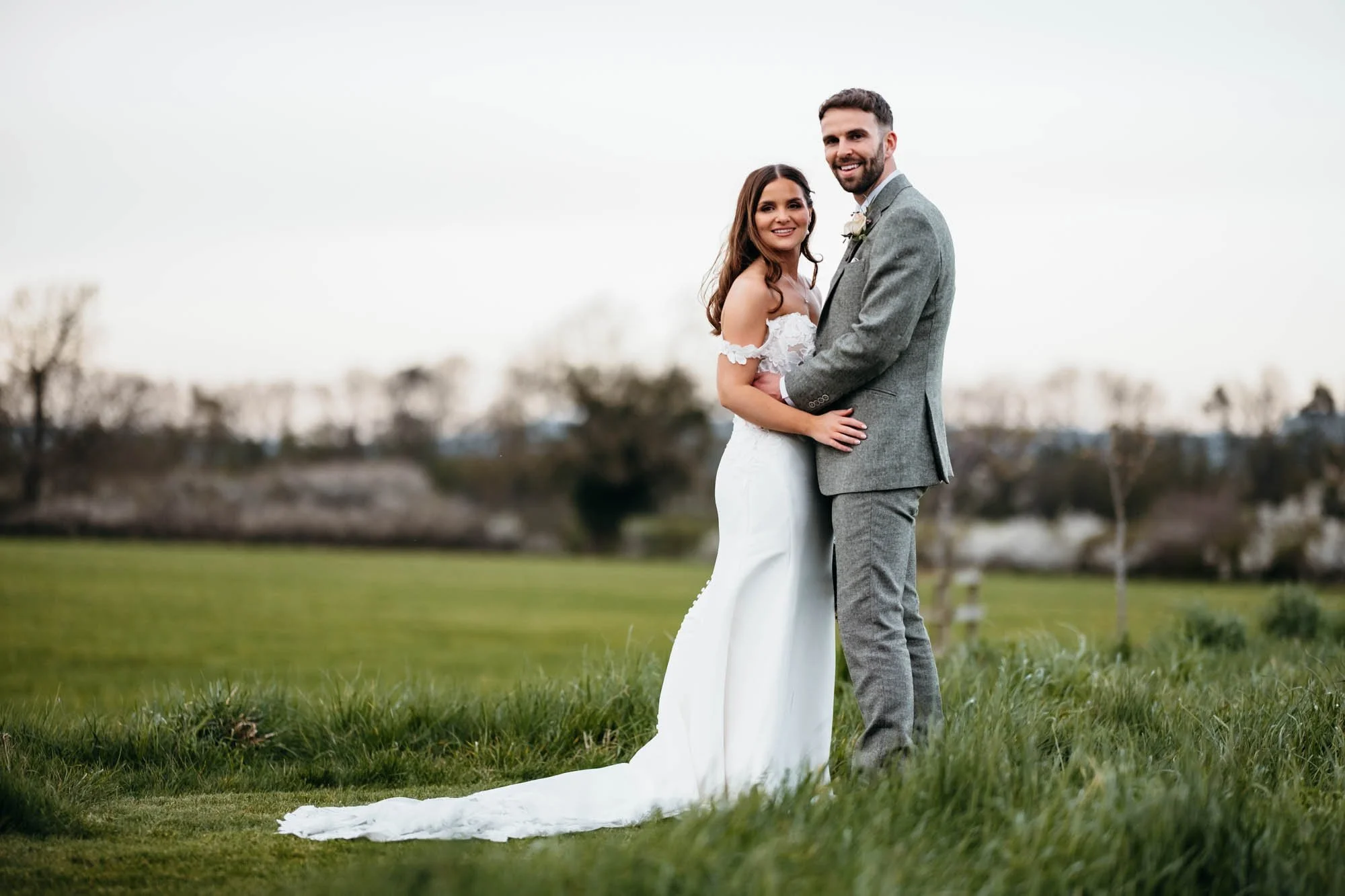 Couple in the fields at golden hour around Thirsk Lodge Barns, North Yorkshire