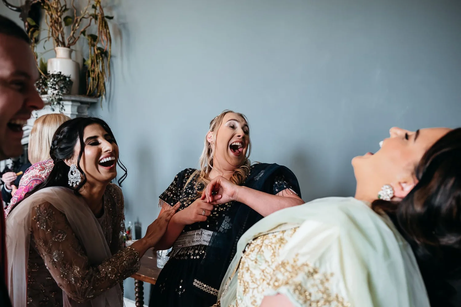 Guests laughing together during the ceremony rituals at a Lartington Hall wedding