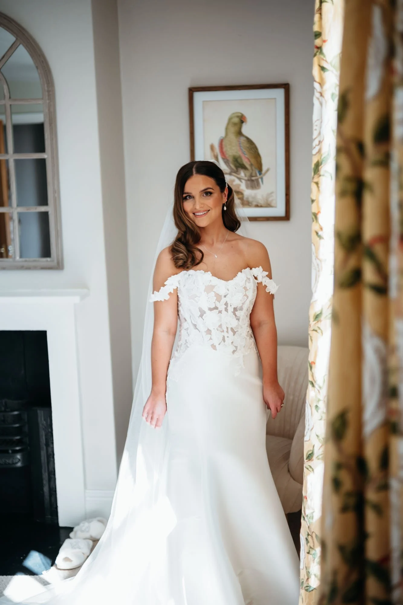Bride standing by the window in the bridal suite before her Thirsk Lodge Barns wedding