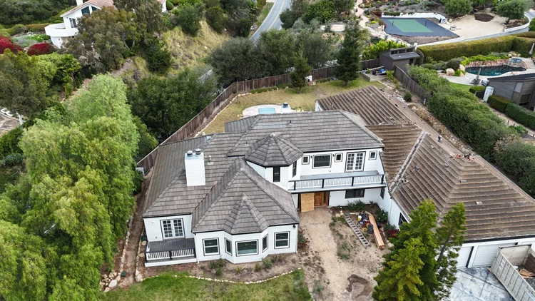 Drone view of the original concrete tile roof as tear-off begins