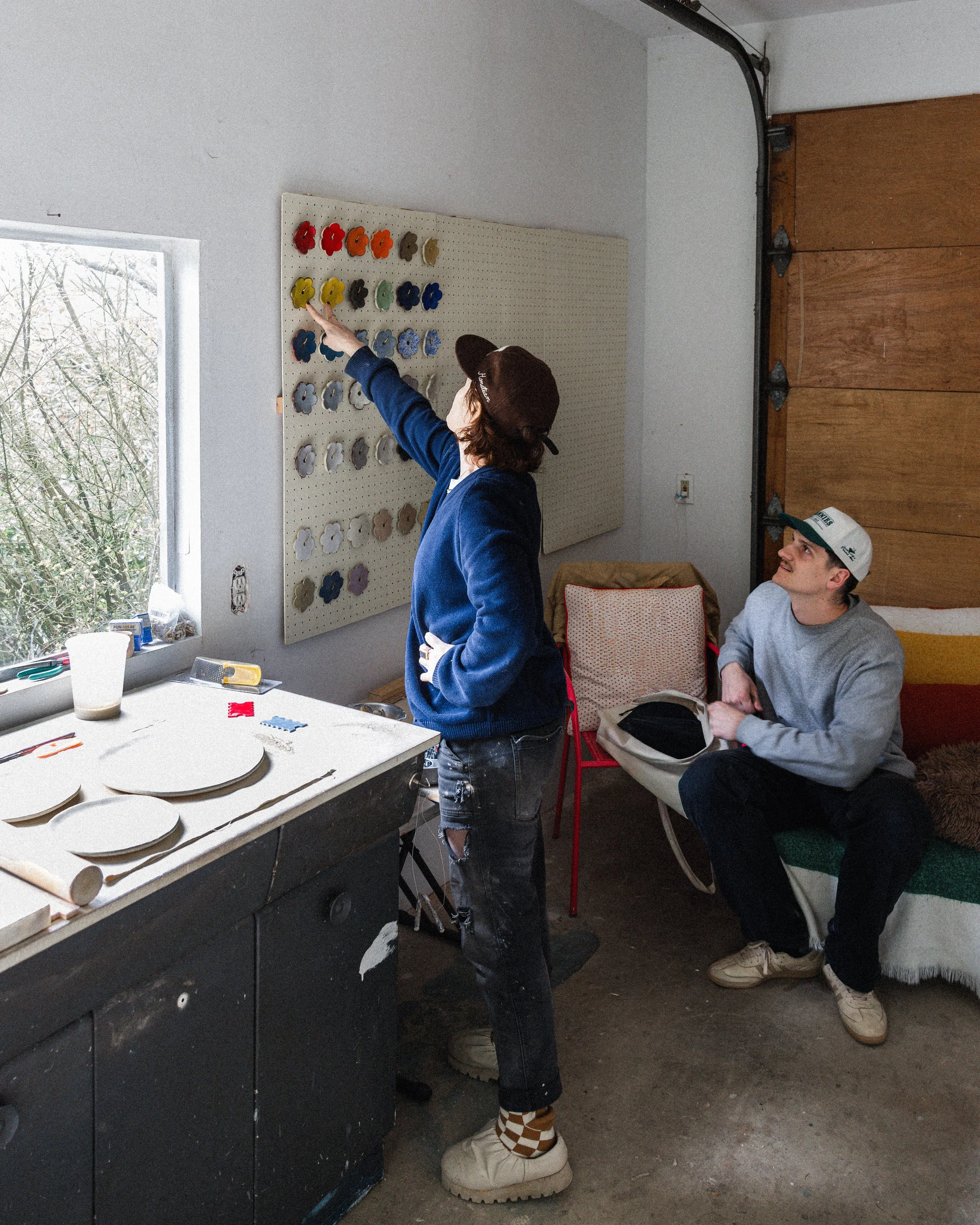 Two people collaborating and reviewing creative work in a studio environment