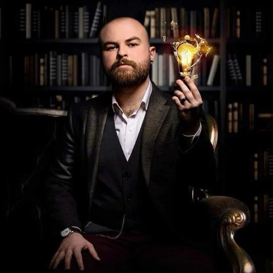 Mentalist Dustin Dean holding a glowing lightbulb