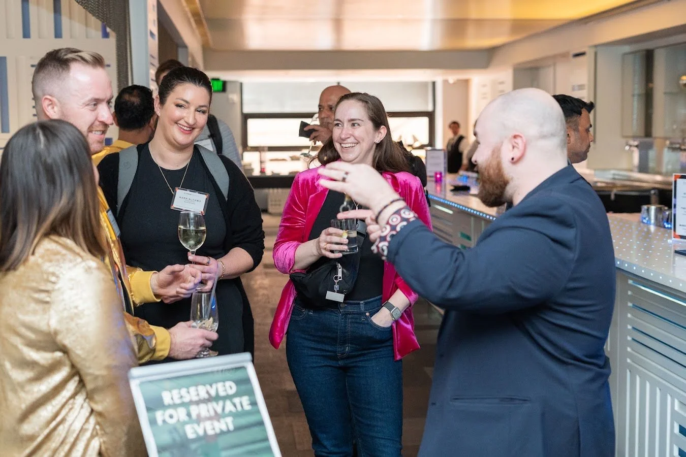 Dustin Dean performing close-up mentalism with a small group at a reception