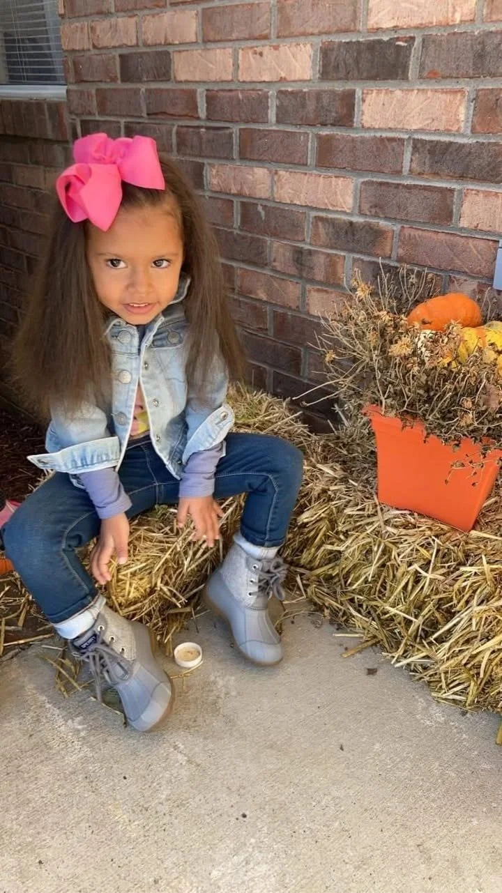 A little girl with a pink bow