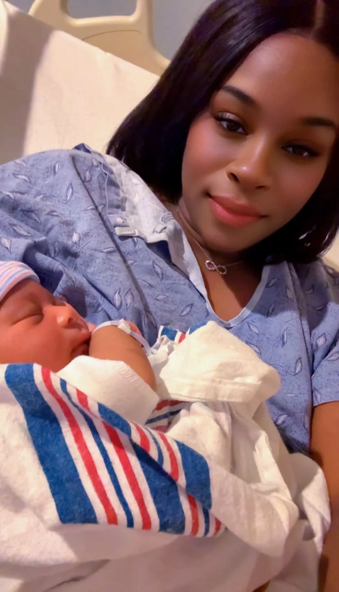 A mom holding her newborn son in the hospital