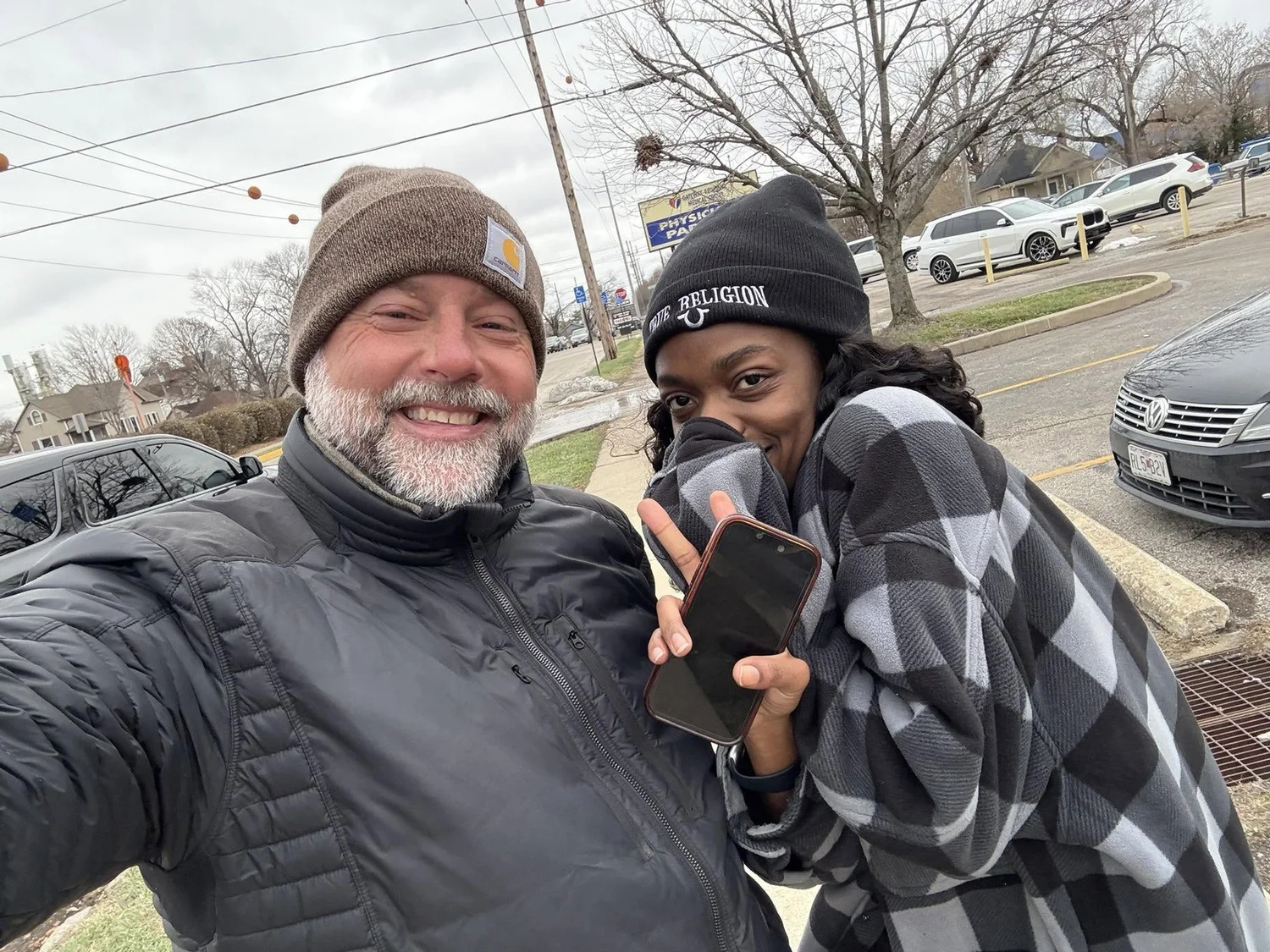 Scott with a young mom outside in the cold