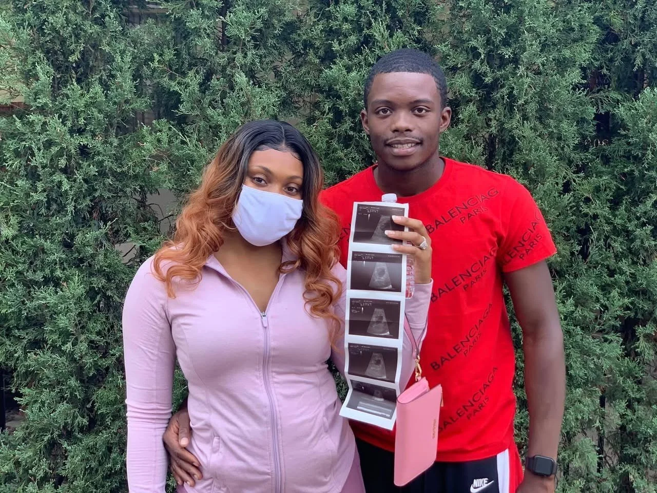 A couple holding ultrasound photos