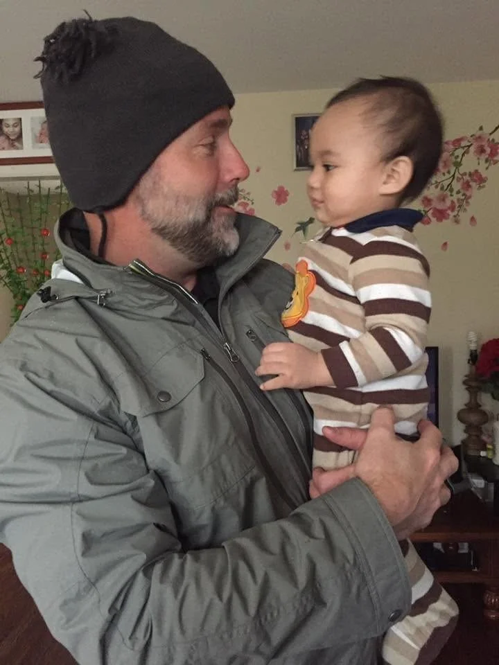 Scott holding a toddler