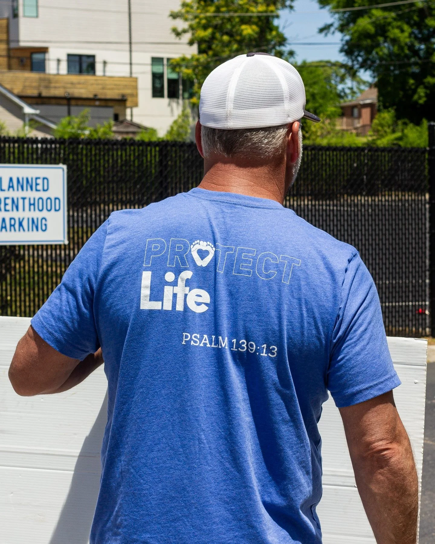 Scott outside Planned Parenthood in a Protect Life shirt