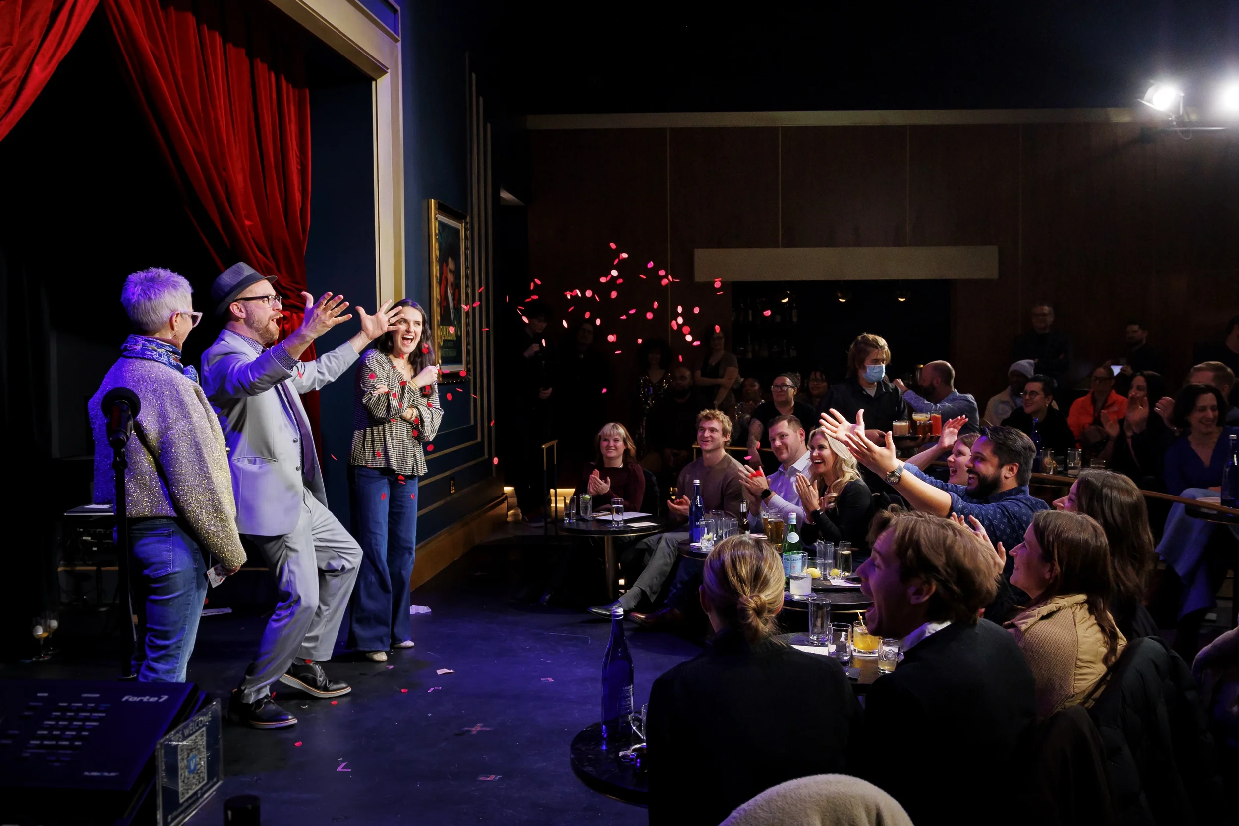 Magician performing at a corporate event with an engaged audience