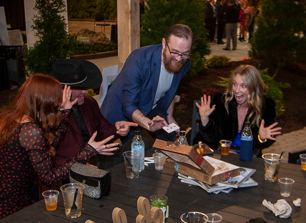 Guests seated at a corporate event watching a magic performance