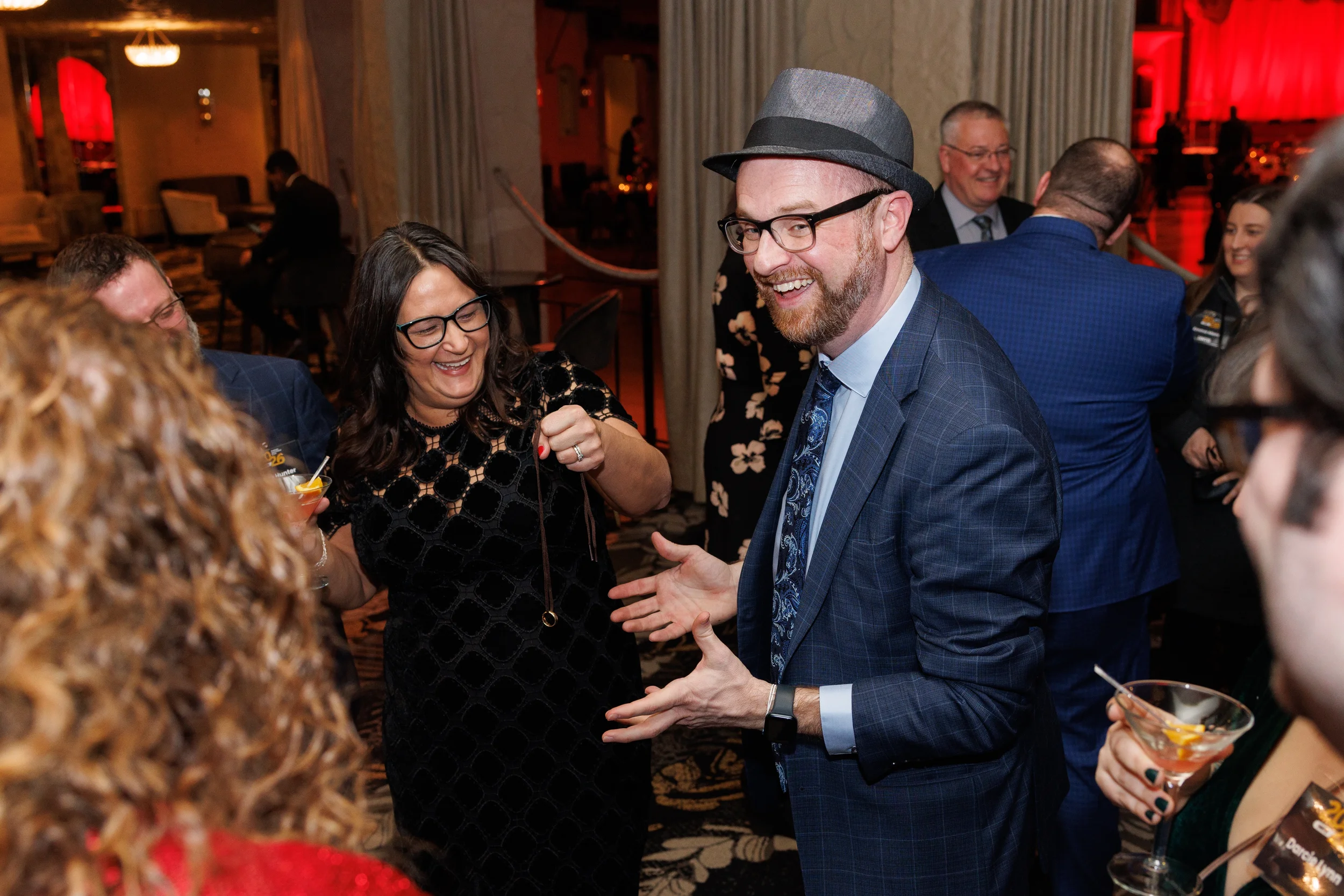 Magician performing a trick for laughing guests at an event