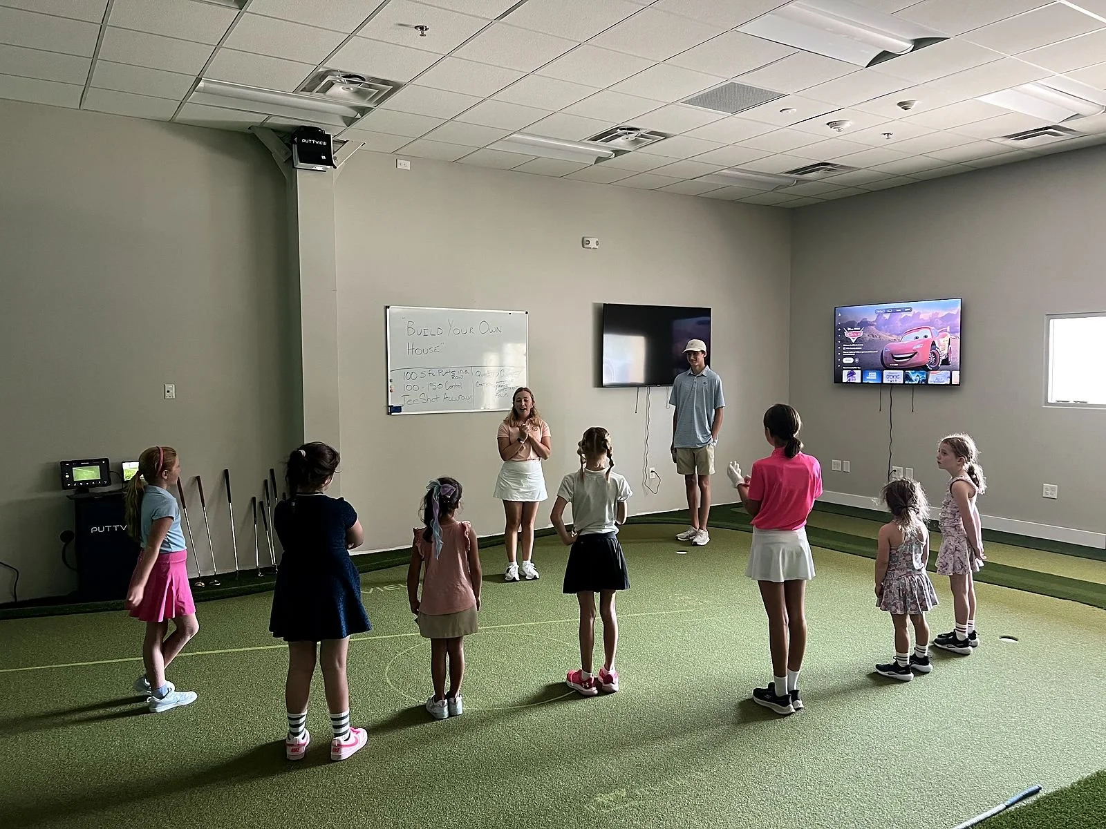 Deb Spair speaking with girls in the Birdies and Besties program at Coastal Golf Academy