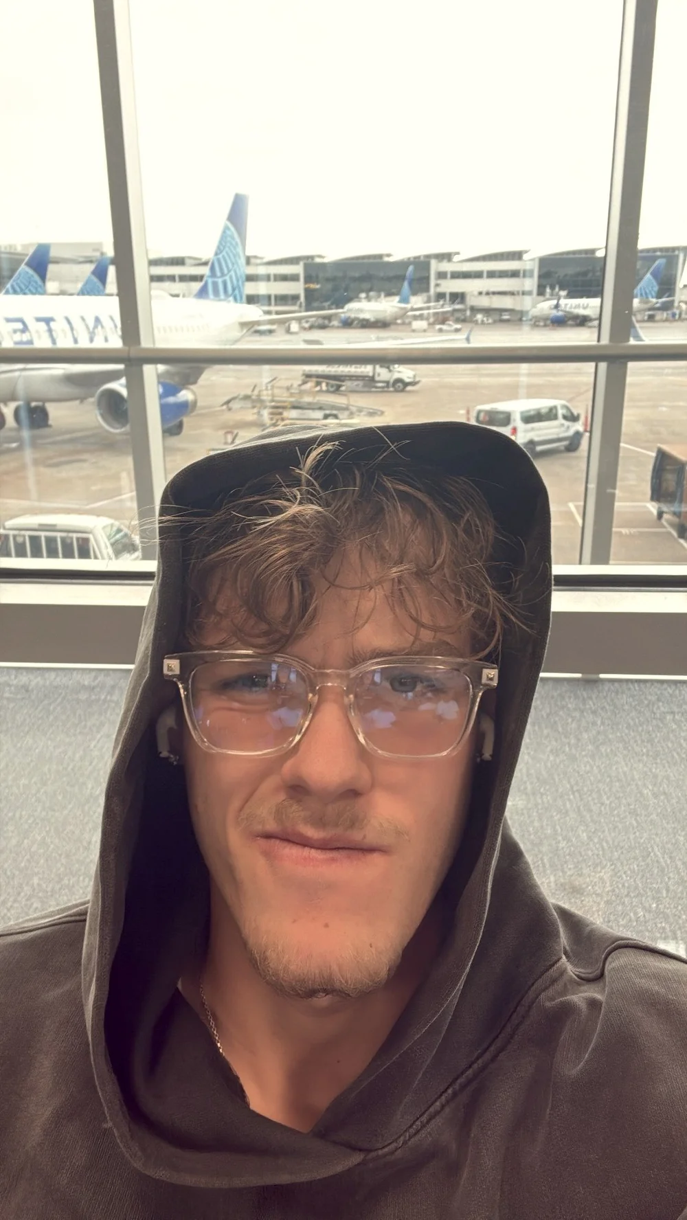 Selfie of Luca in a hoodie at the airport