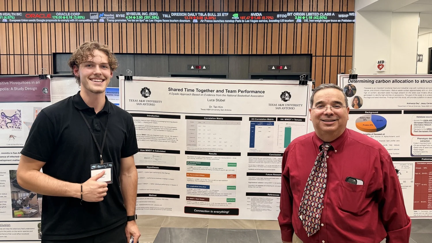 Luca presenting his research poster to the president of Texas A&M University–San Antonio