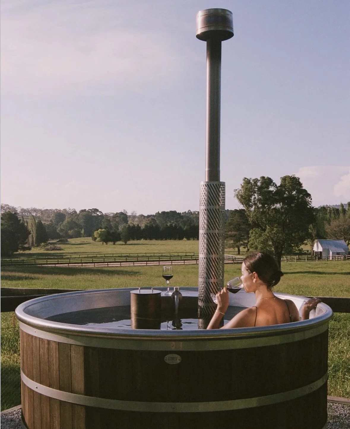 Wood-fired hot tub on a misty Southern Highlands evening at Boscobel Estate — horses grazing alongside in the fog, Sutton Forest NSW