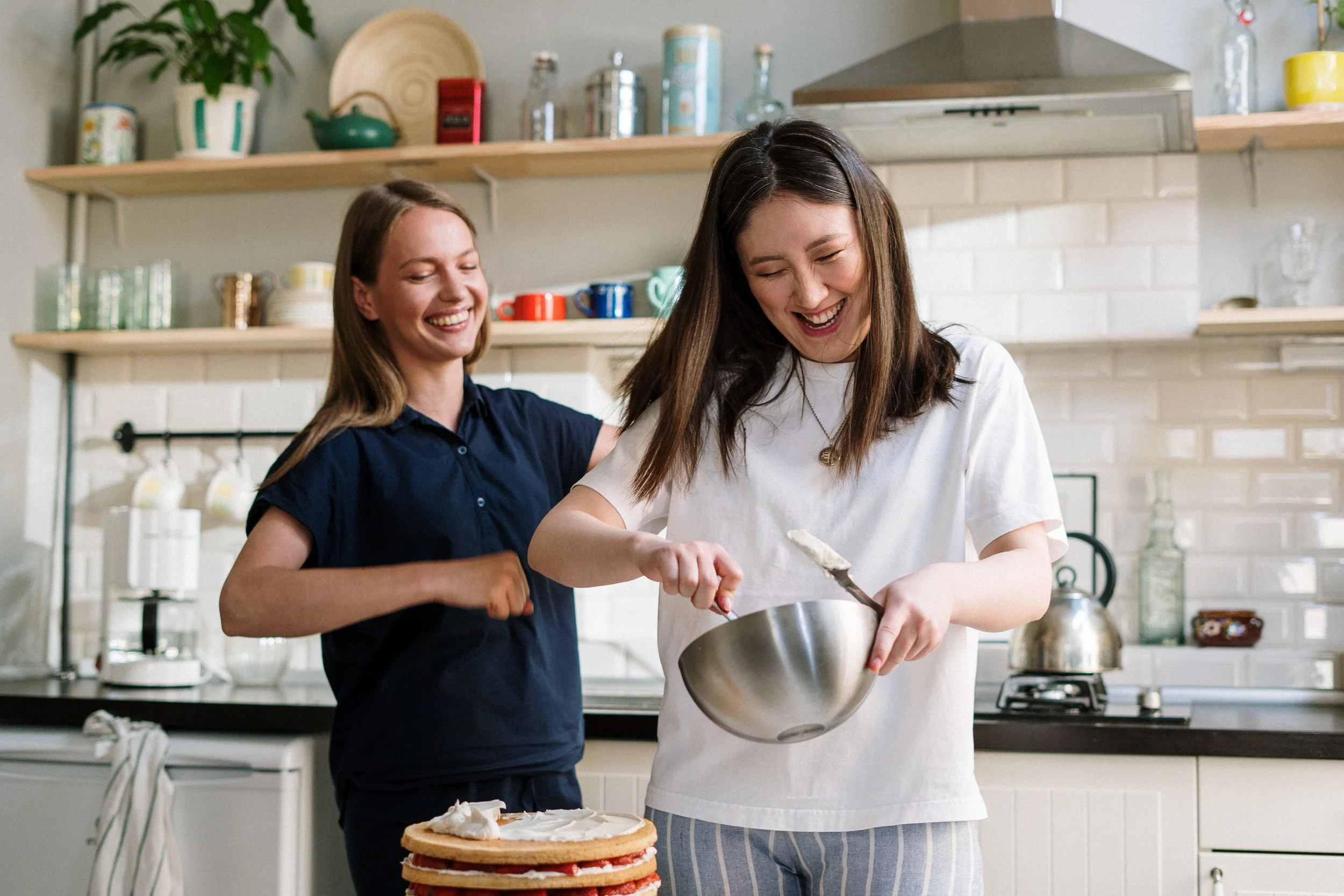 Two girls cooking and laughing