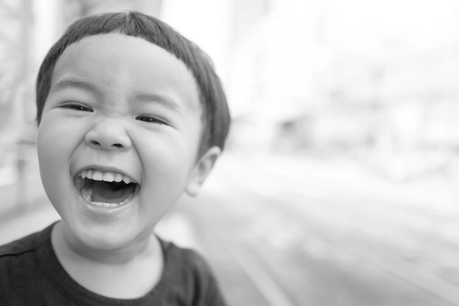 A young child laughing, relaxed and unafraid