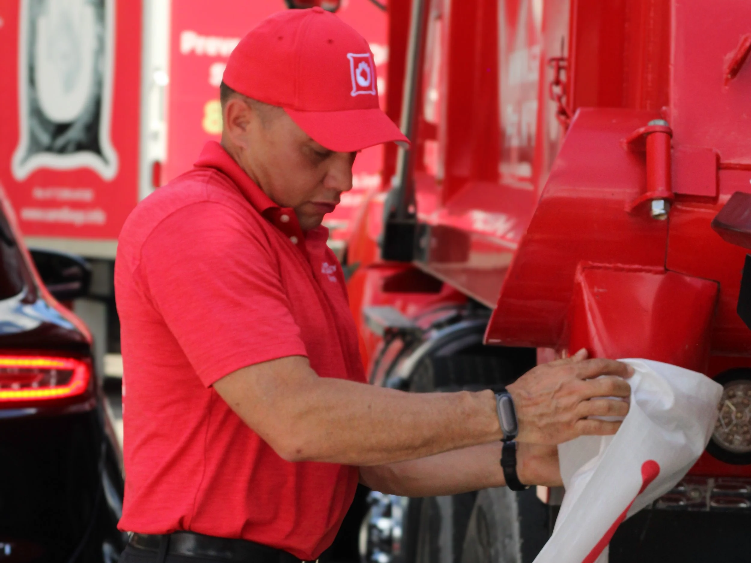 ESR CEO Albert Sotero operating the company's patented high-speed automated sandbag filling machine (Patent No. 11,390,401 B2) during a municipal flood response deployment.