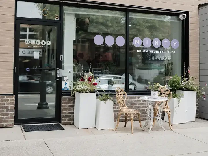 The MINTY storefront at 496 Brant St, with gold bistro chairs and white planters out front