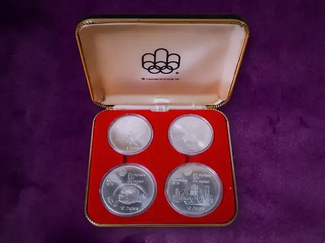 A cased set of four 1976 Montreal Olympic silver coins on purple velvet