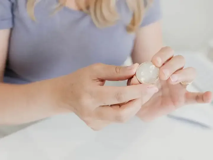 Hands holding a silver coin