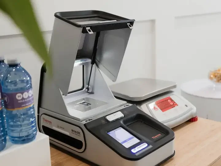 An XRF analyzer and a digital scale on the MINTY testing counter