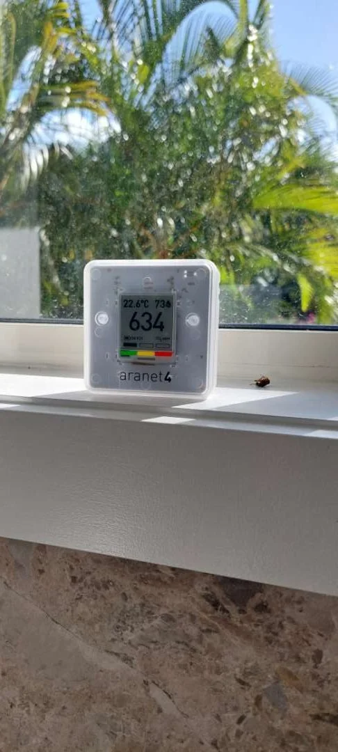Environmental monitor positioned in a bathroom during a room assessment.