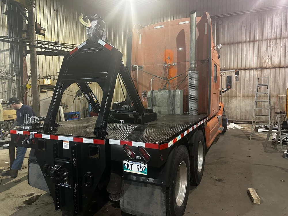 Rear of the truck with the steel lifting arm in the shop