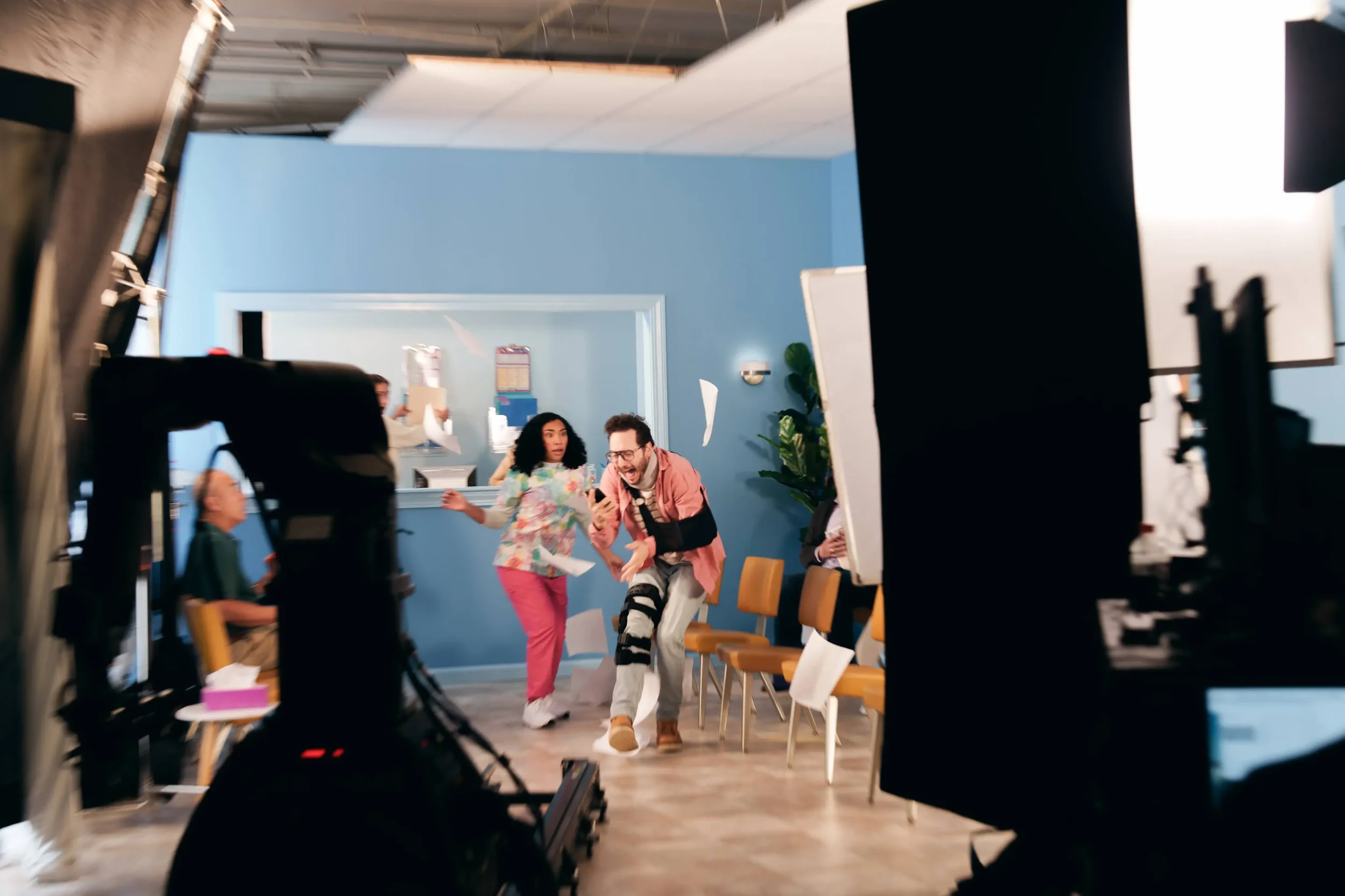 Production crew filming in a studio kitchen set