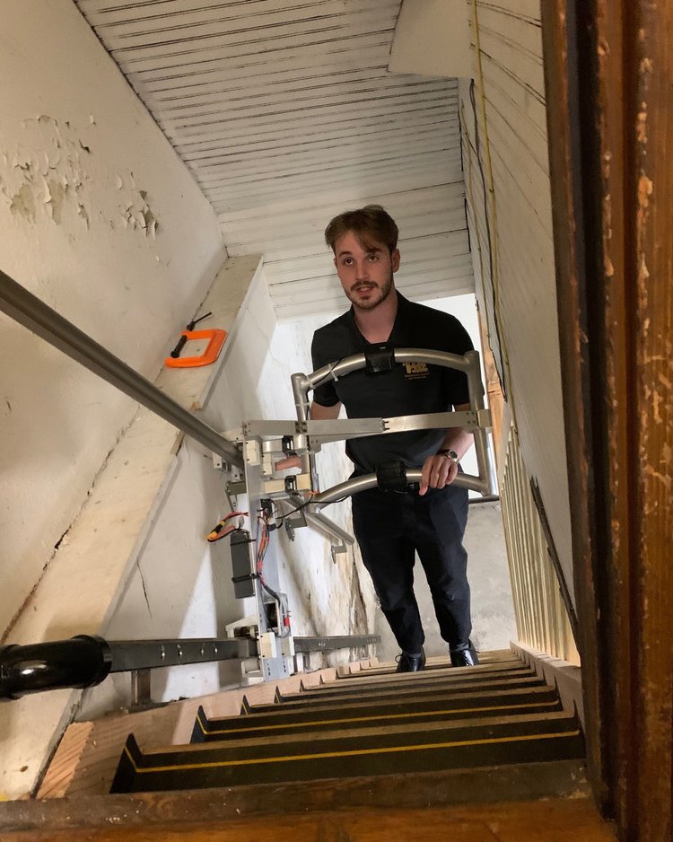 A younger man demonstrates stair climbing technology.