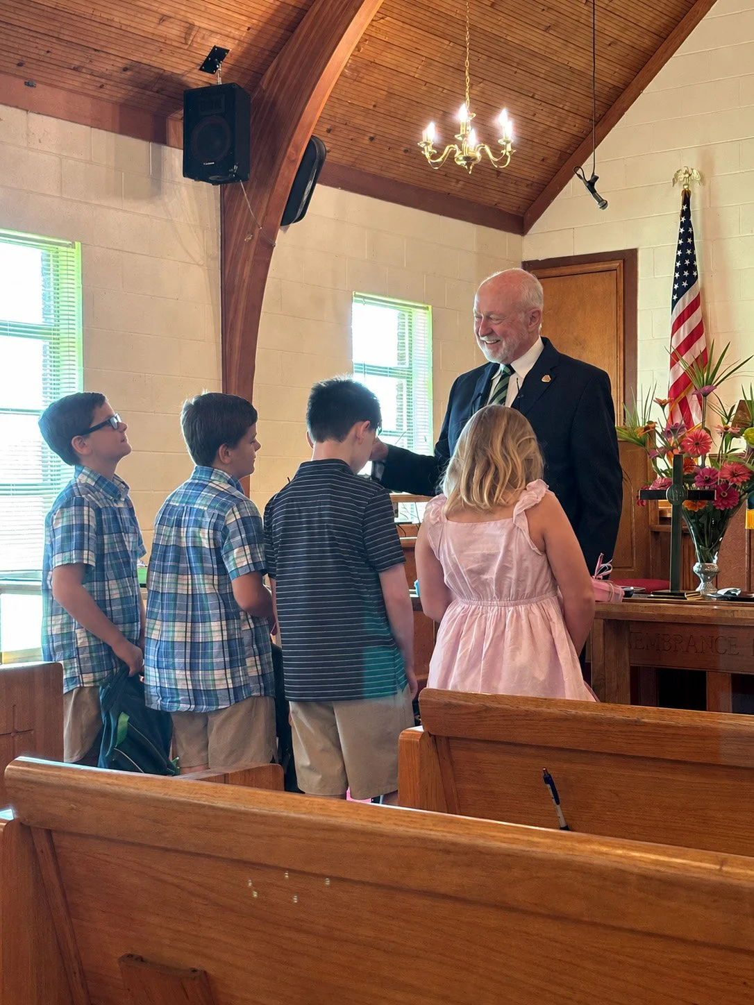 Children gathered with a pastor at Trinity-Selma