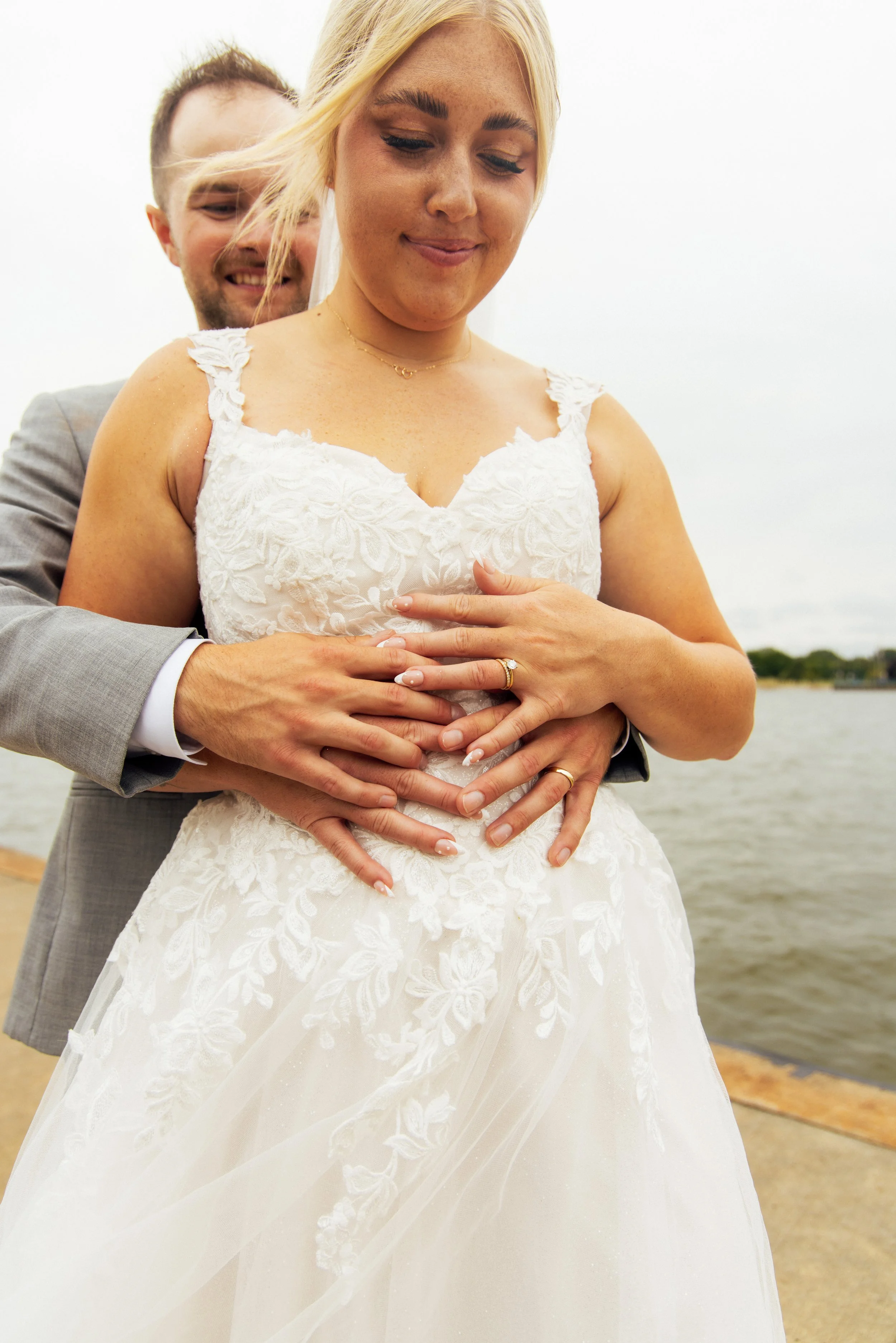 Close photograph of Noah and Jenna's wedding rings and hands